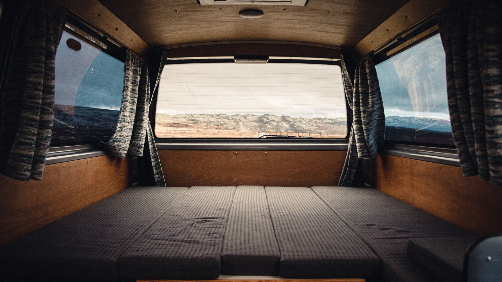 Illustrative open rear interior of a van with broad floor space and windows