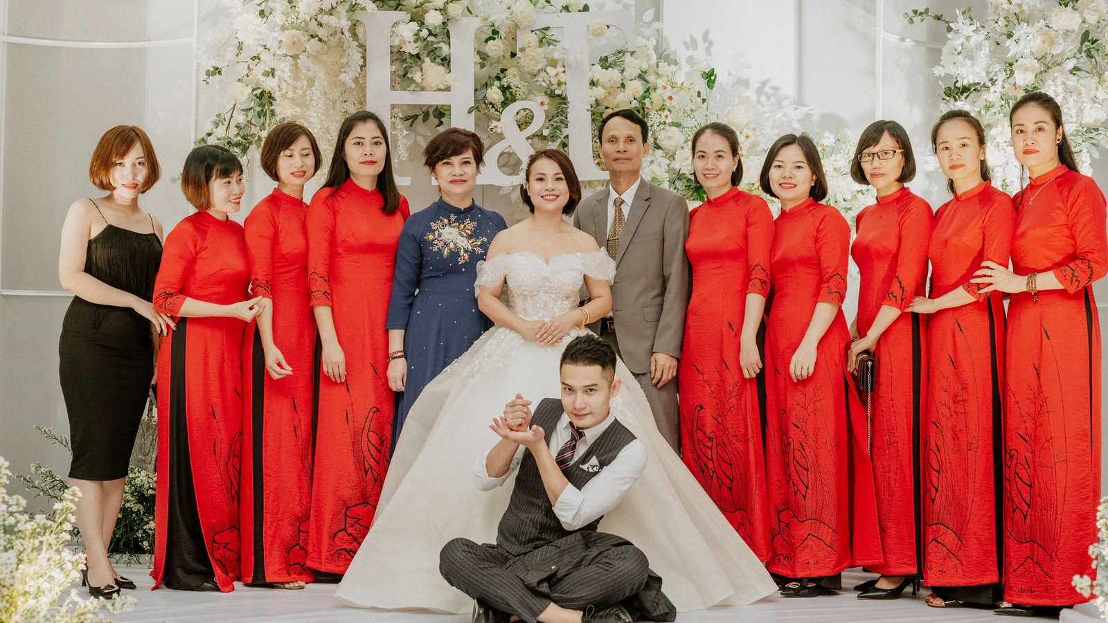 Newlyweds and wedding party members smiling together during a wedding celebration.