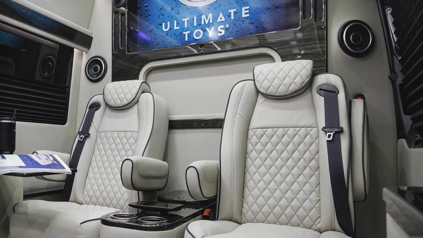 Illustrative Dufourfun-owned luxury van cabin with two light quilted seats and an overhead screen; not photographed at Keeneland.